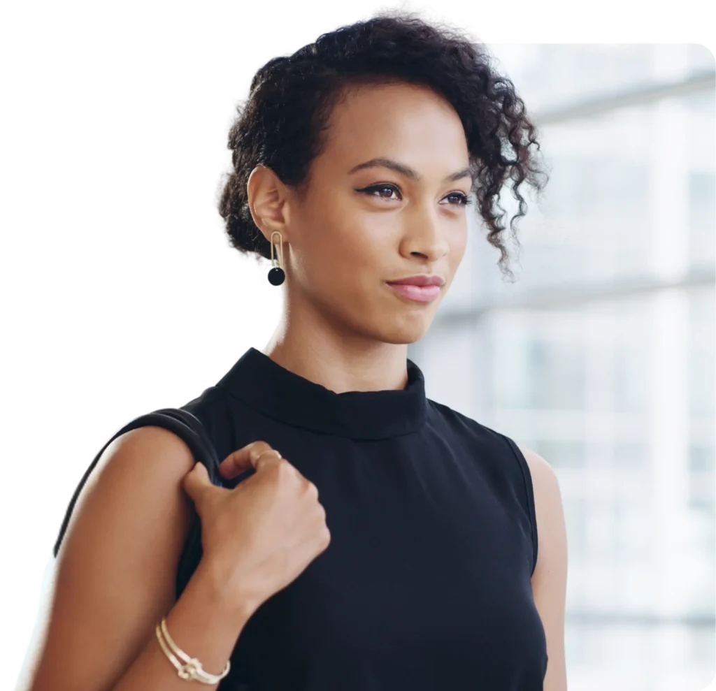 Confident professional woman in black dress carrying a bag, symbolizing empowered leadership and personal expansion through Dr. Ashley’s high-level coaching program, Full Expansion.